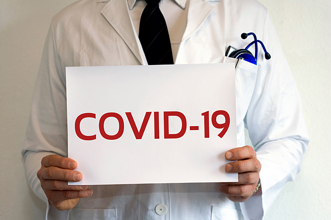 Corona Covid-19 Arzt Pandemie Virus Warnschild